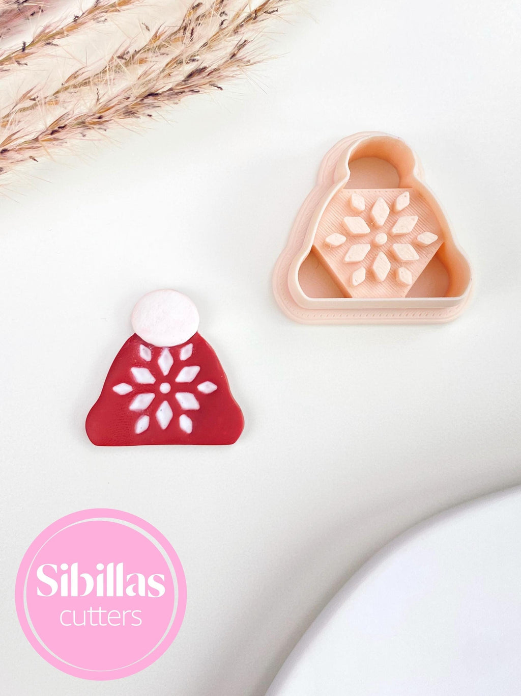Polymer clay cutter featuring Christmas beanie design with ornaments for festive jewelry