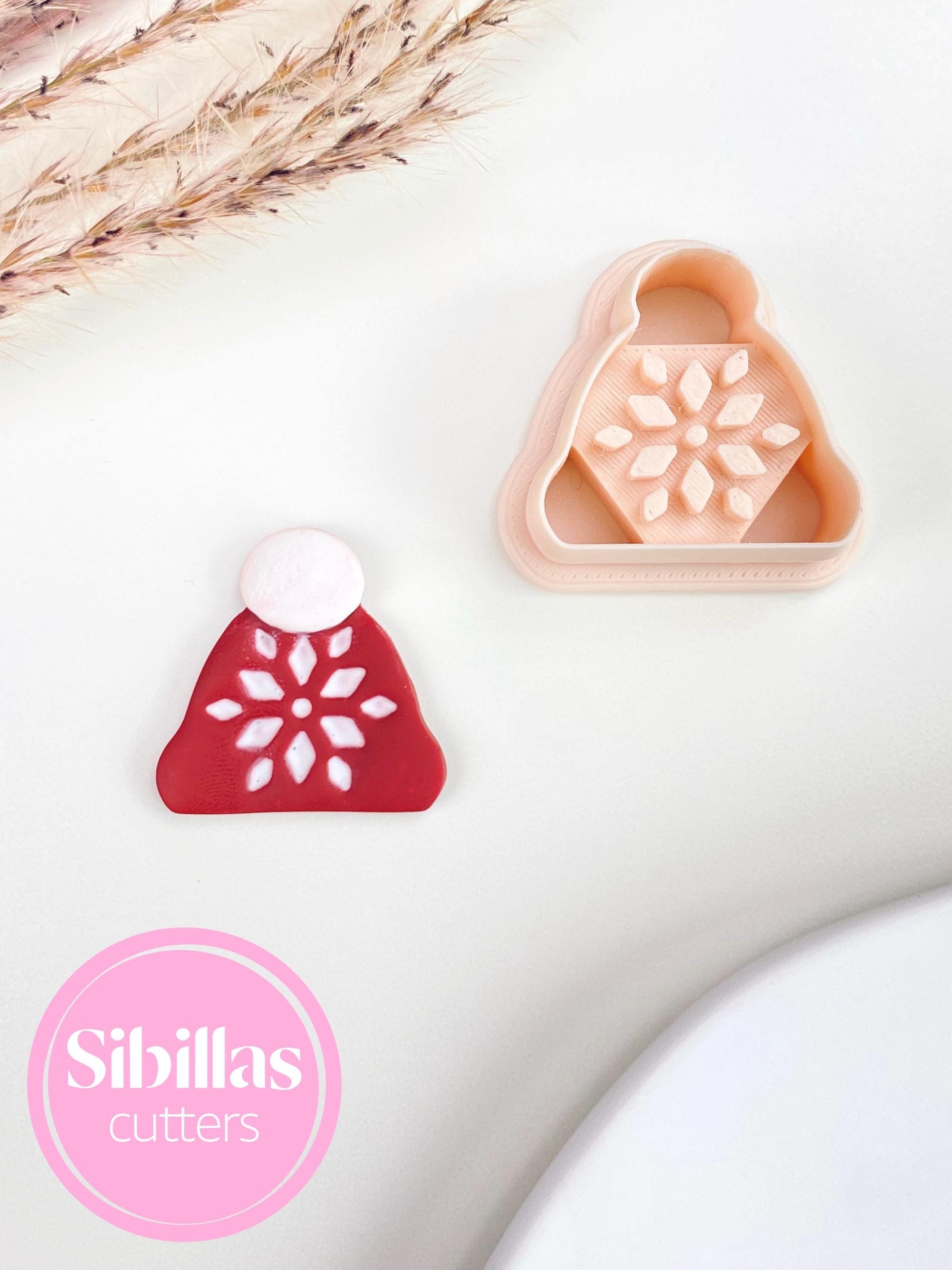 Polymer clay cutter featuring Christmas beanie design with ornaments for festive jewelry