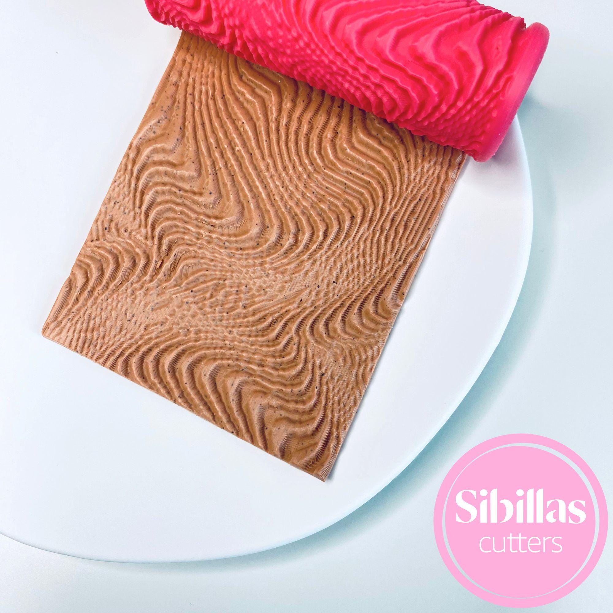 Polymer clay embossing roller featuring modern abstract line pattern for crafts