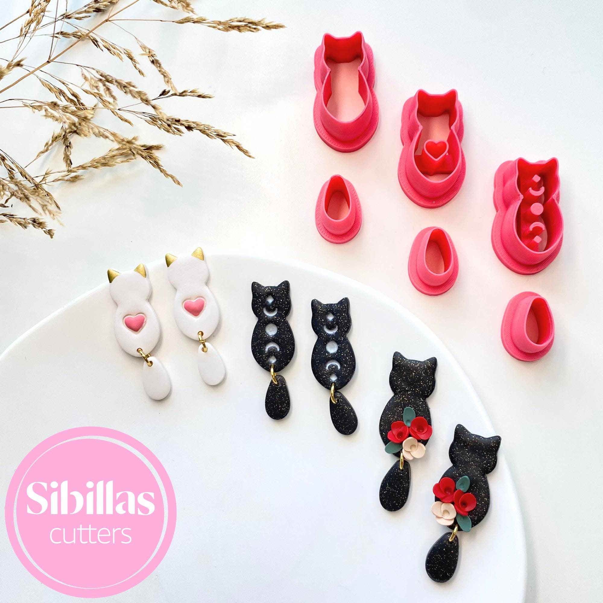 Cat-shaped cookie cutters on a white plate with 'Sibillas Cutters' branding.