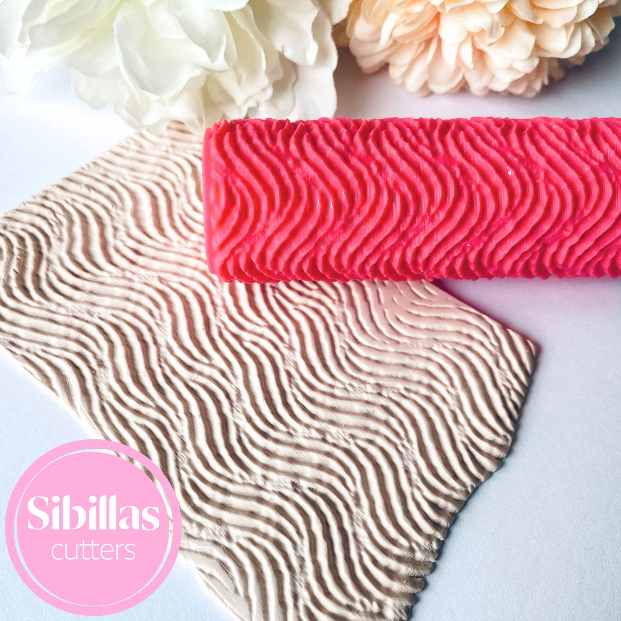 Embossing roller featuring abstract lines design for polymer clay projects