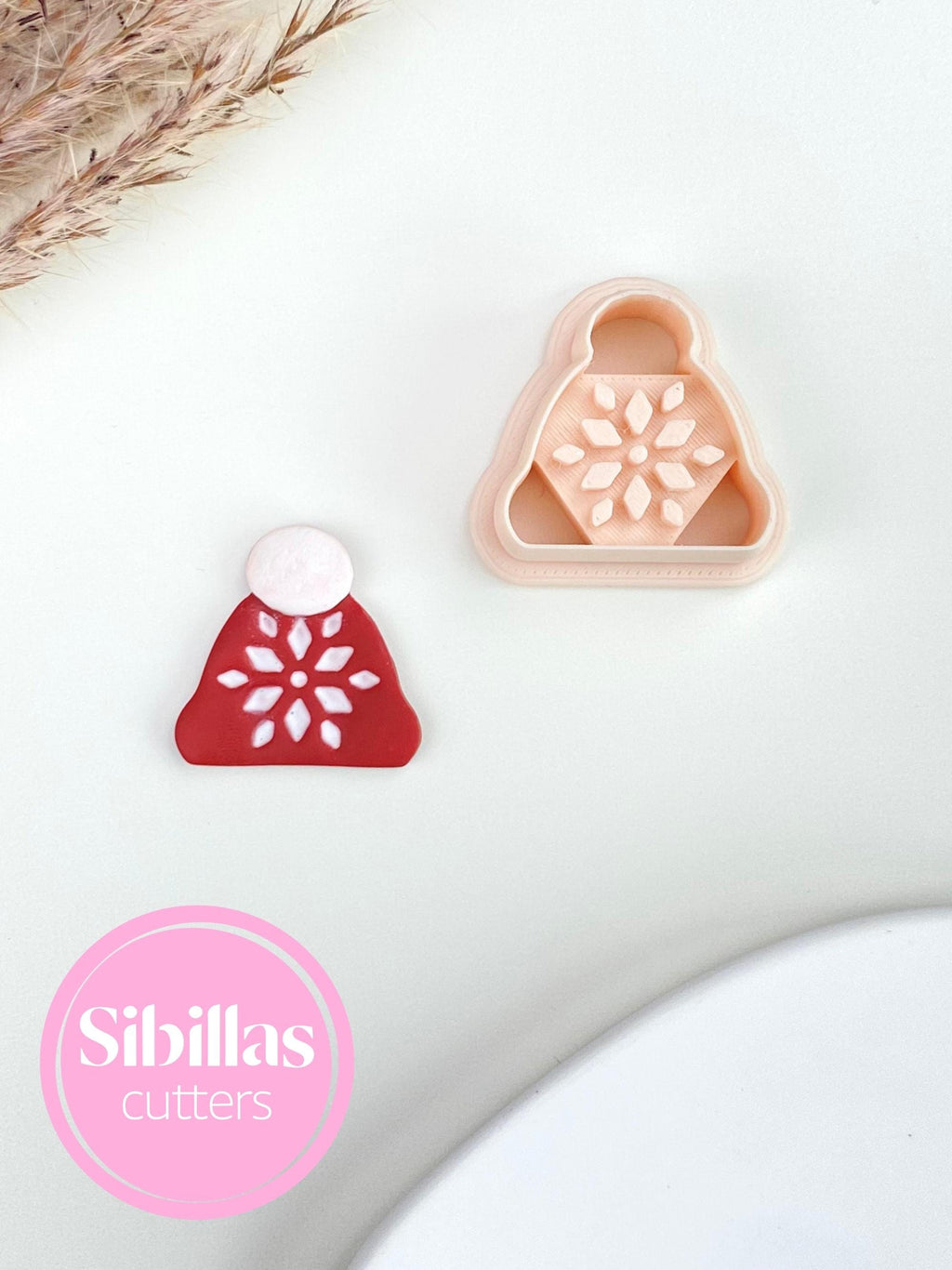 Polymer clay cutter featuring Christmas beanie design with ornaments for festive jewelry