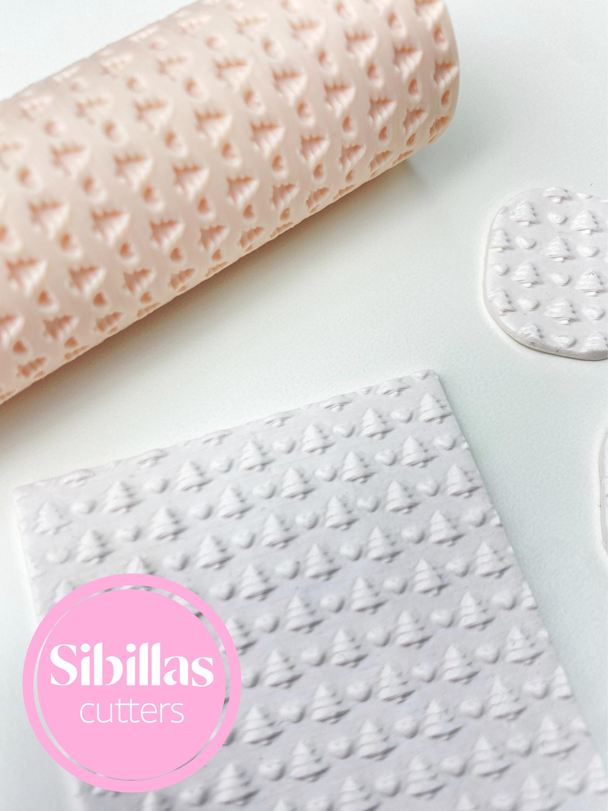 Polymer clay texture tool featuring festive Christmas tree and hearts design