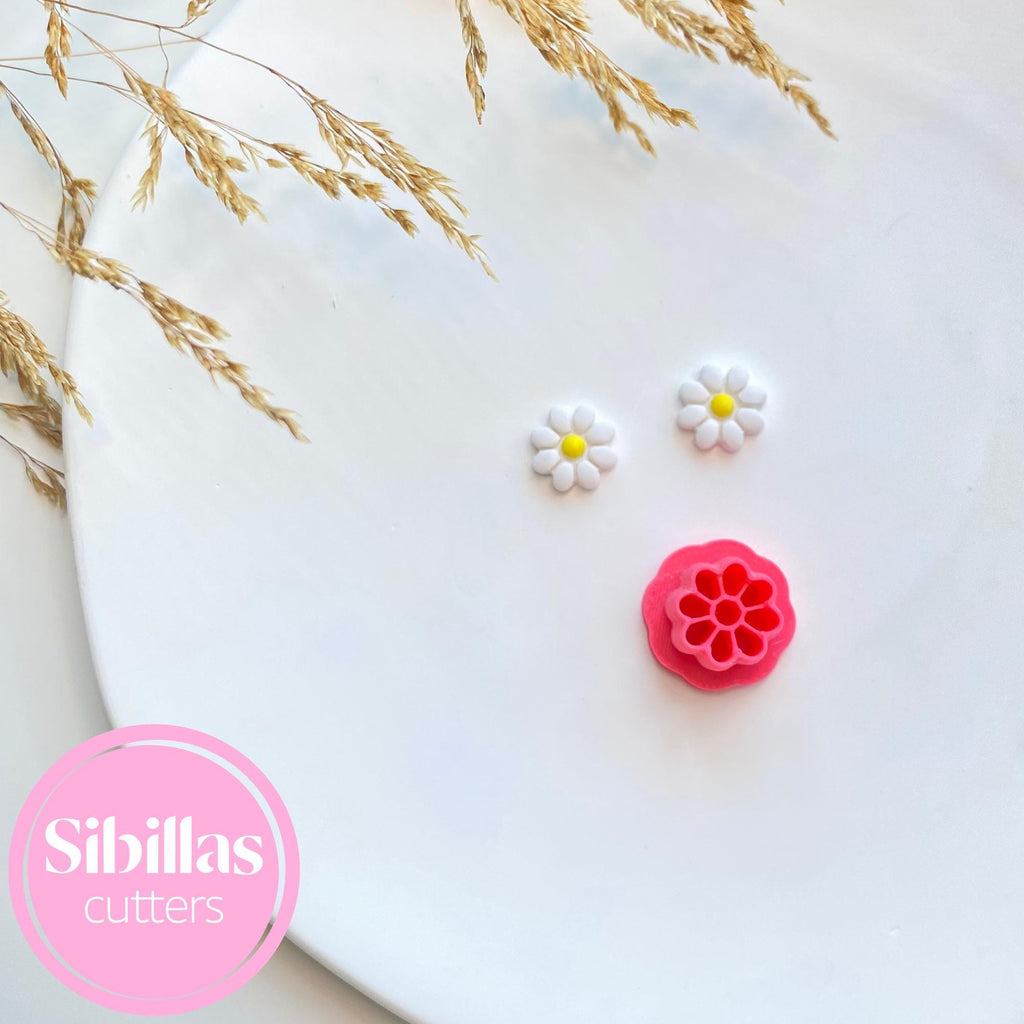Two floral-shaped cookie cutters on a white surface with 'Sibillas Cutters' branding.