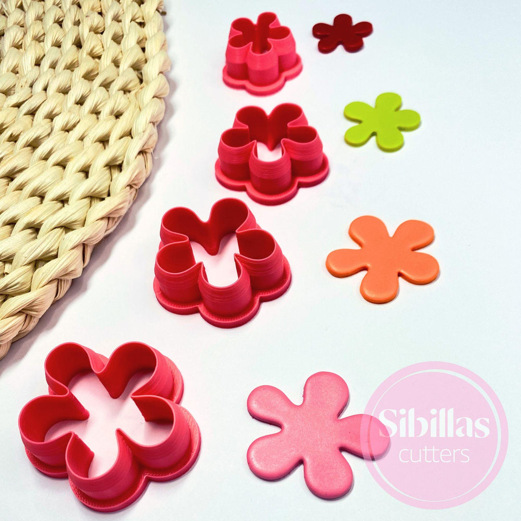 Set of colorful flower-shaped cookie cutters on a white surface with 'Sibillas cutters' branding.