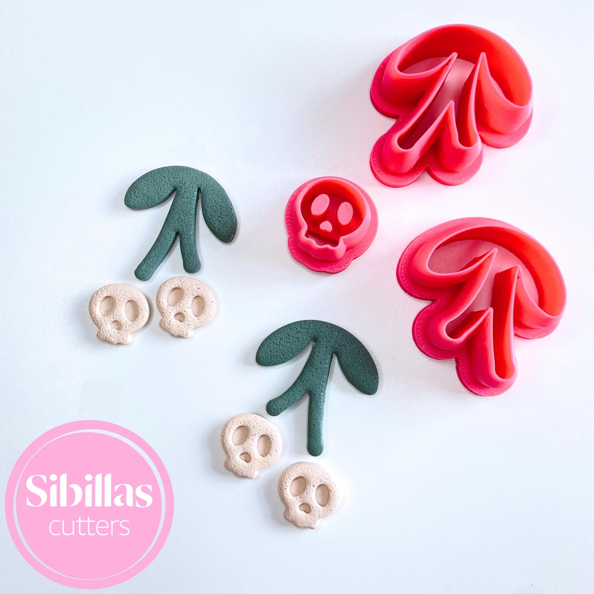 Polymer clay cutter shaped like a cherry skull for spooky handmade jewelry
