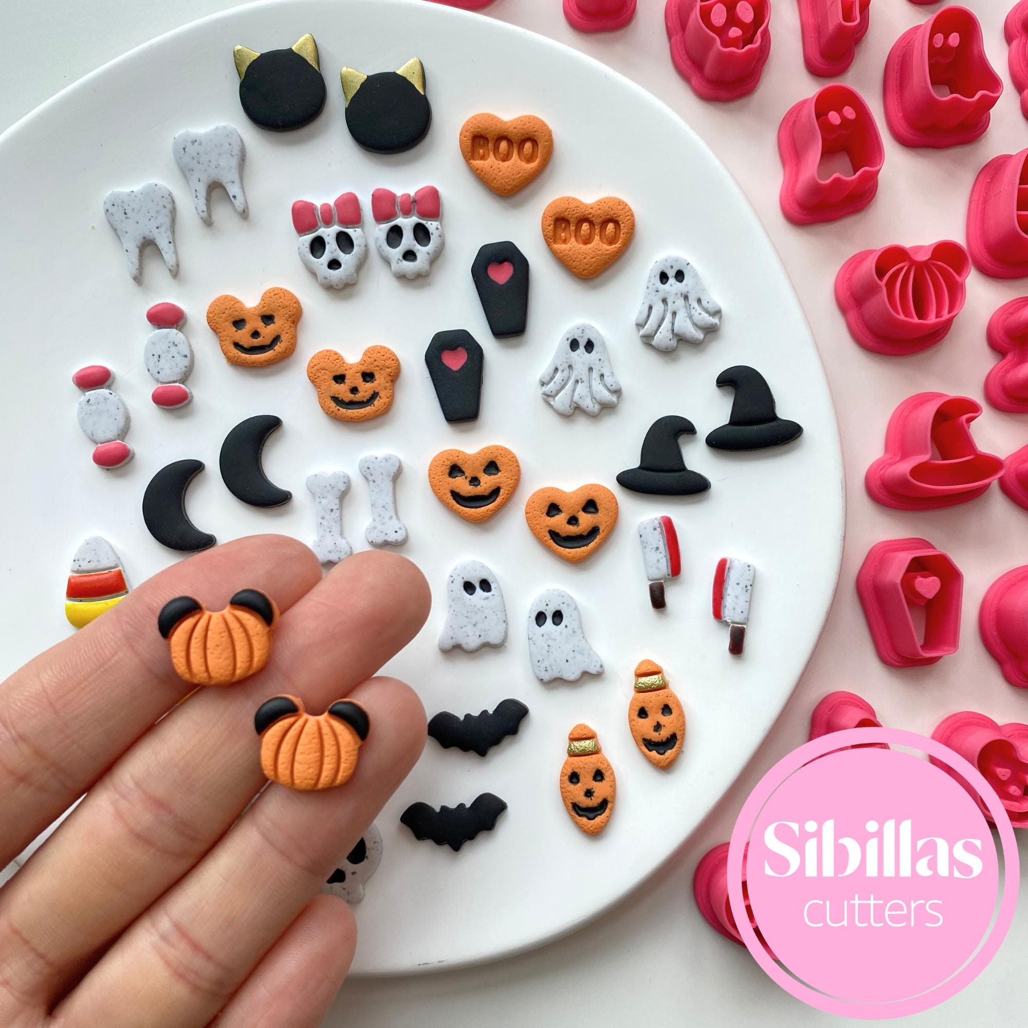 assorted Halloween polymer clay shapes including pumpkins, ghosts, bats, and skulls