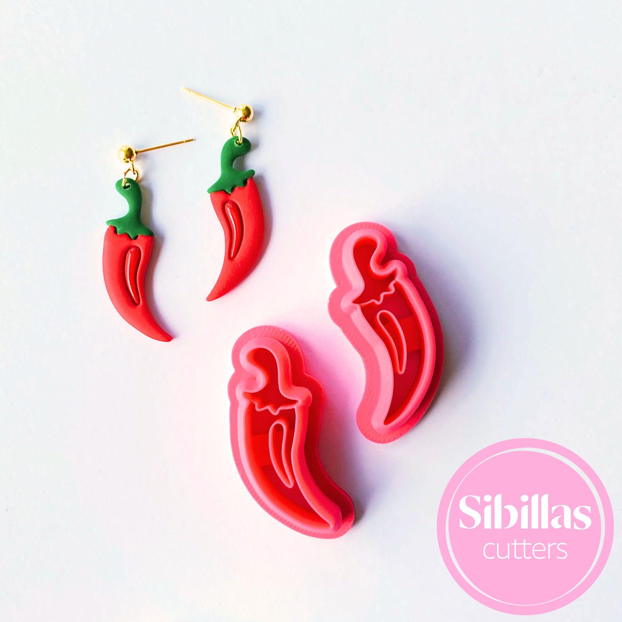 Red chili pepper-shaped earrings and cutters on a white background with 'Sibillas cutters' branding.