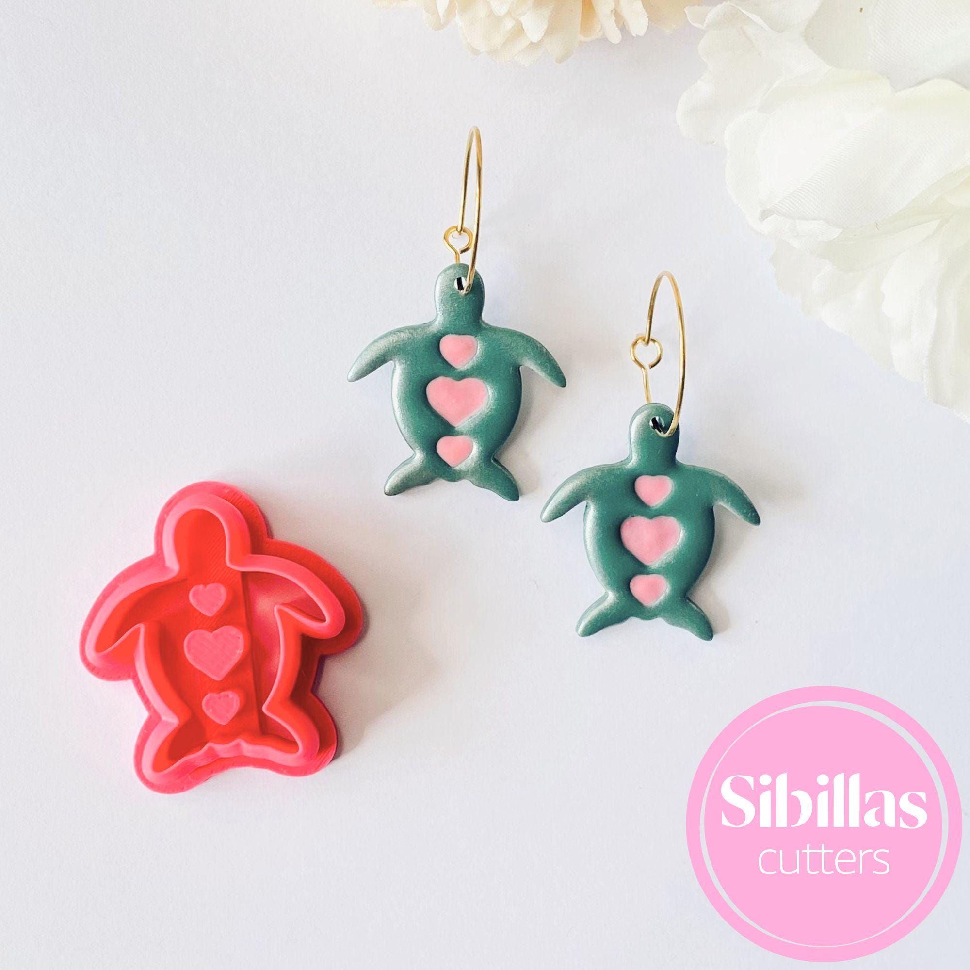 Turtle-shaped cookie cutters with heart designs on a white background, branded 'Sibillas Cutters'.